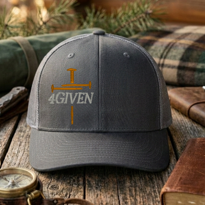 Charcoal & Grey cap with embroidered cross & '4GIVEN' text on a wooden surface with outdoor items.