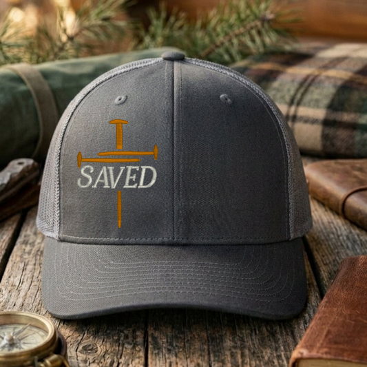 Gray cap with 'Fearless Faith' text on a wooden surface with outdoor items.
