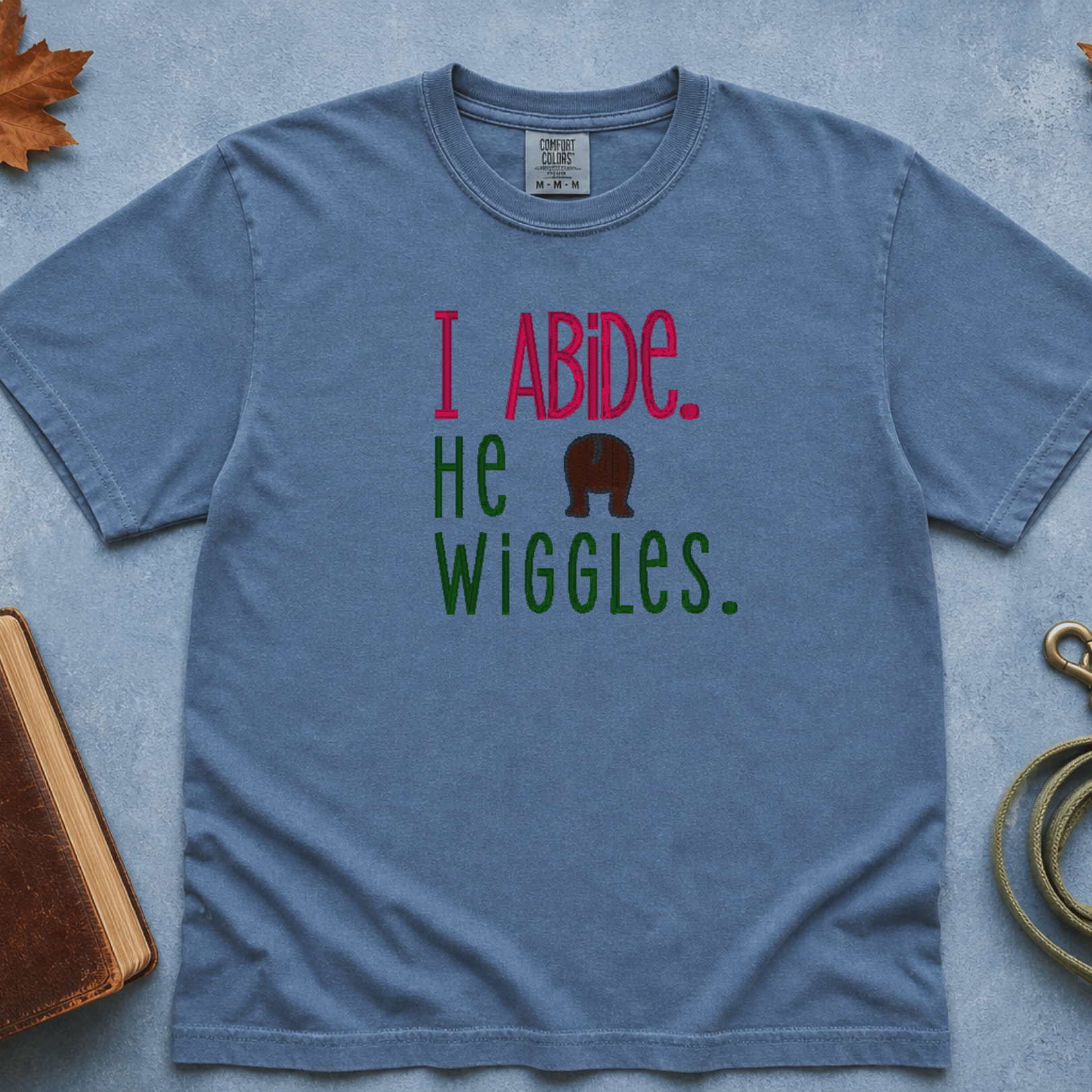 I Abide He Wiggles Comfort Colors Tee in Blue Jean flatlay