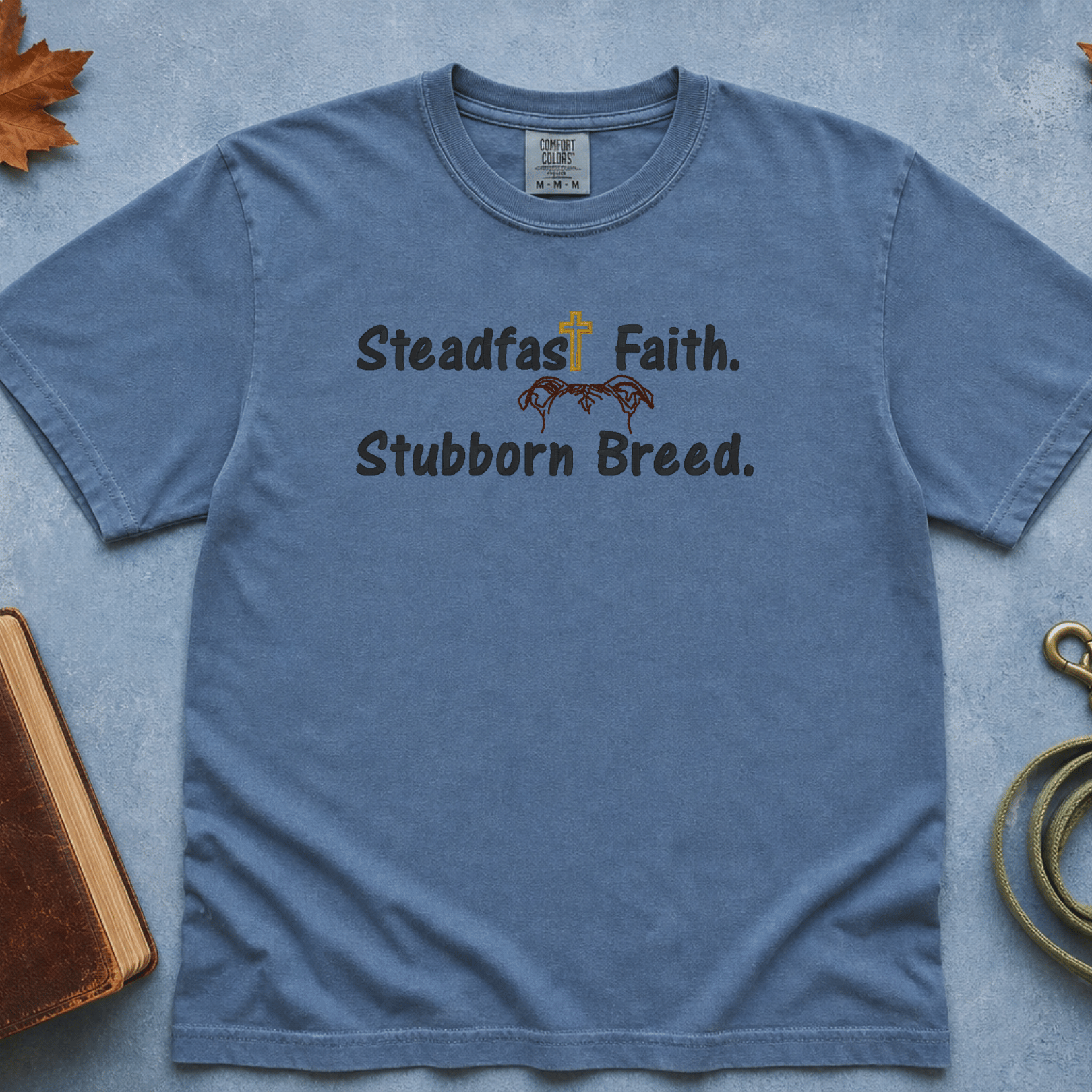 Steadfast Faith Stubborn Breed Comfort Colors Tee in Blue Jean flatlay
