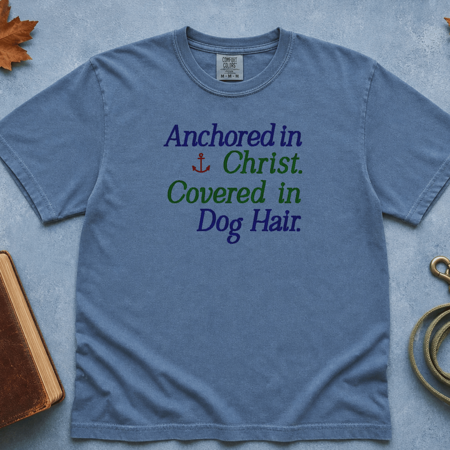 Anchored in Christ Covered in Dog Hair Comfort Colors Tee in Blue Jean flatlay