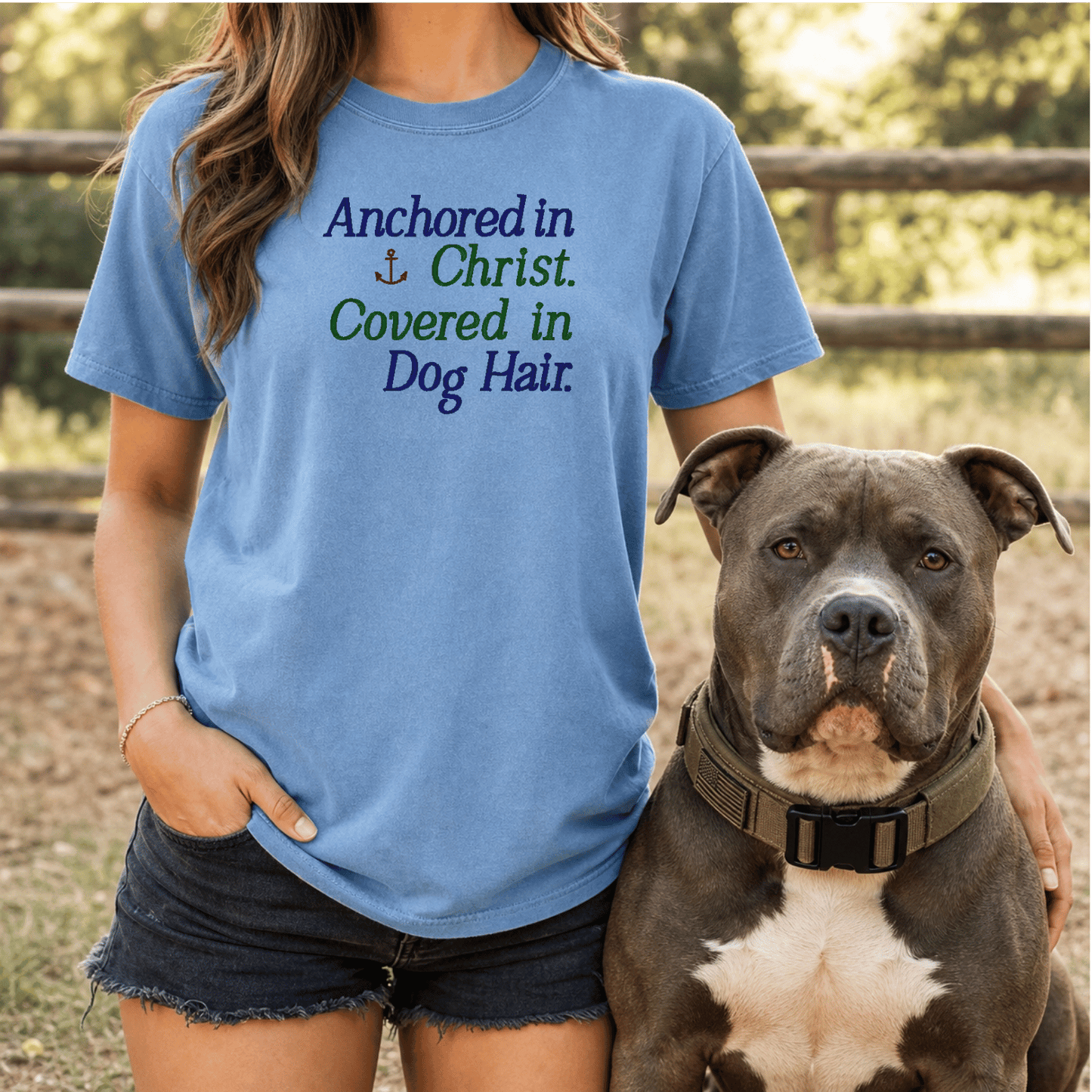 Woman wearing Anchored in Christ Covered in Dog Hair tee in Blue Jean with bully breed dog