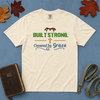Built Strong Covered by Grace Comfort Colors Tee in Ivory flatlay with Holy Bible and dog leash