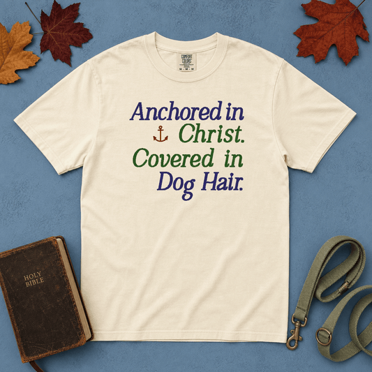 Anchored in Christ Covered in Dog Hair Comfort Colors Tee in Ivory flatlay