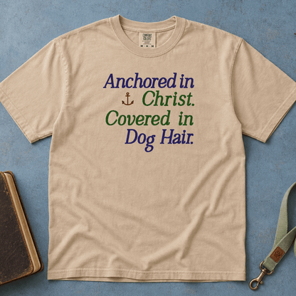 Anchored in Christ Covered in Dog Hair Comfort Colors Tee in Sandstone flatlay