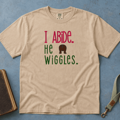 I Abide He Wiggles Comfort Colors Tee in Sandstone flatlay with Holy Bible and dog leash