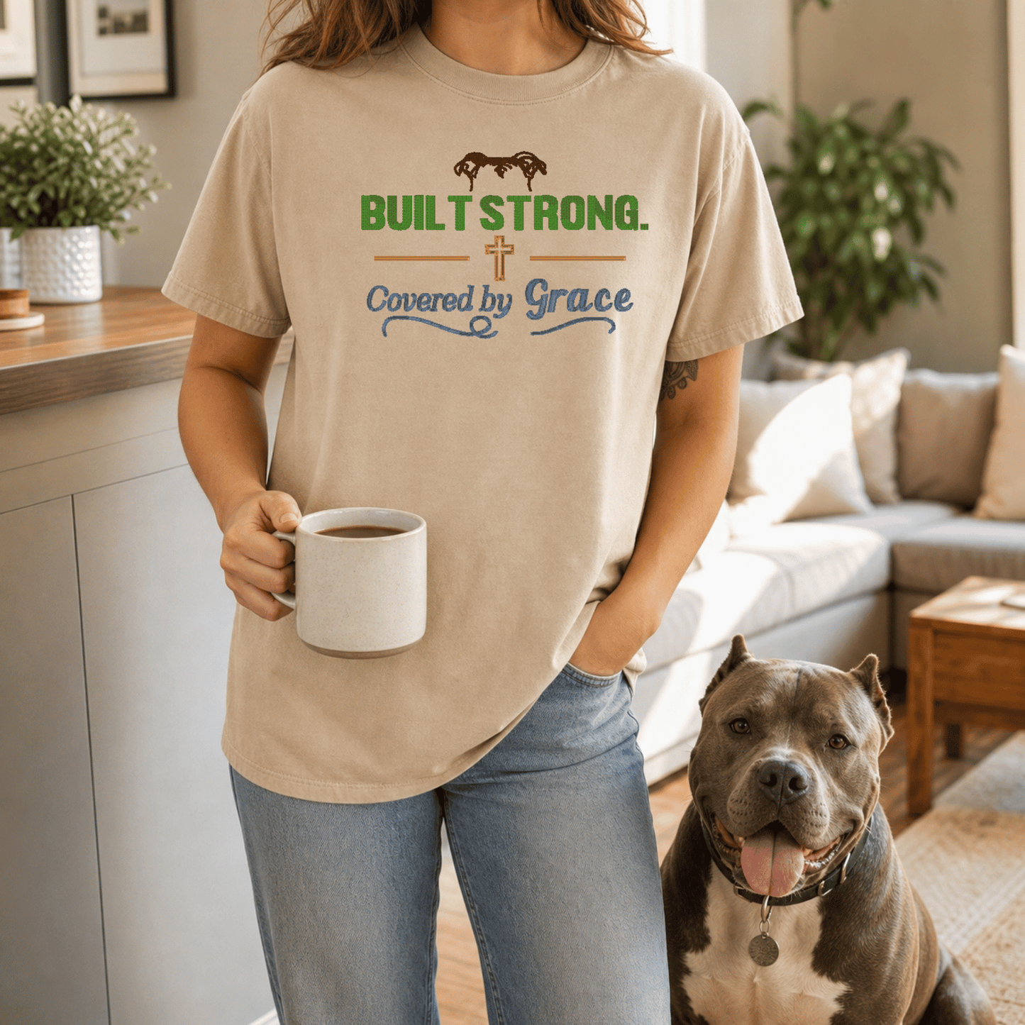 Woman wearing Built Strong Covered by Grace tee in Sandstone standing with bully breed dog outdoors
