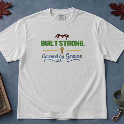 Built Strong Covered by Grace Comfort Colors Tee in White flatlay with autumn leaves and dog leash